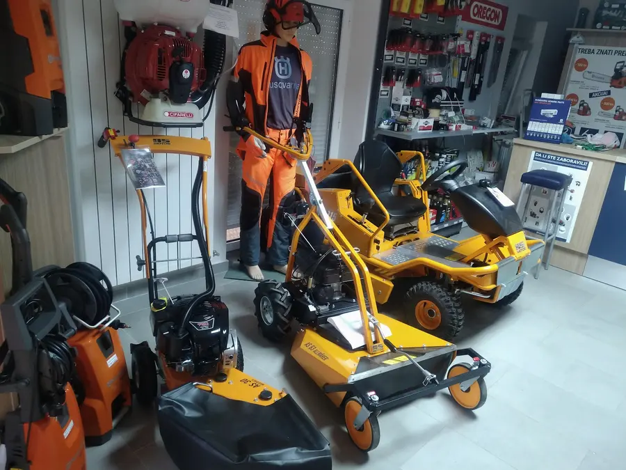 AS-Motor kosilice, lutka u zaštitnoj opremi i zid s dijelovima u trgovini